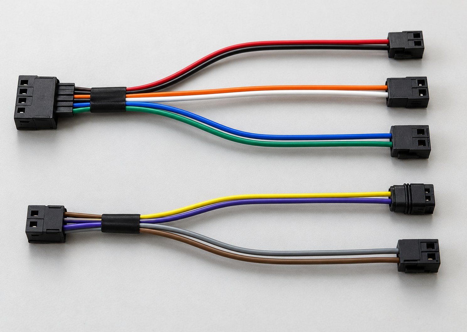 Two prototype wire harness assemblies with multi-pin connectors and branched wires laid out for inspection